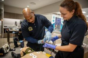 Male and female EMT students standing next to each other